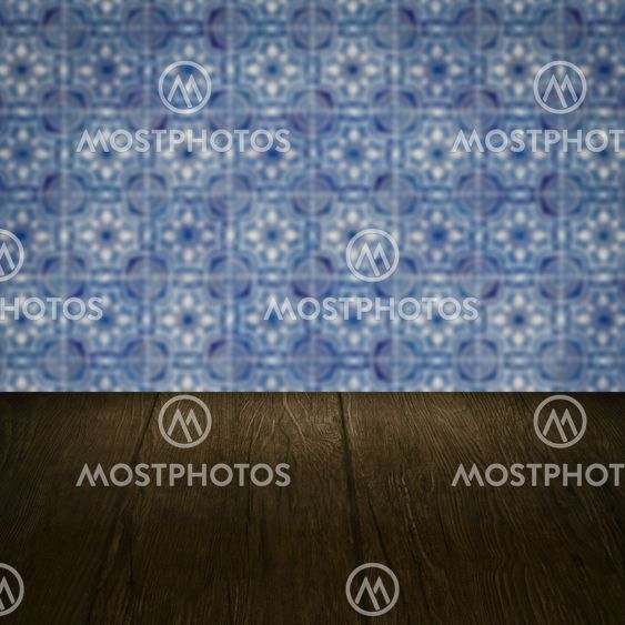 Wood table top and blur vintage ceramic tile pattern wall