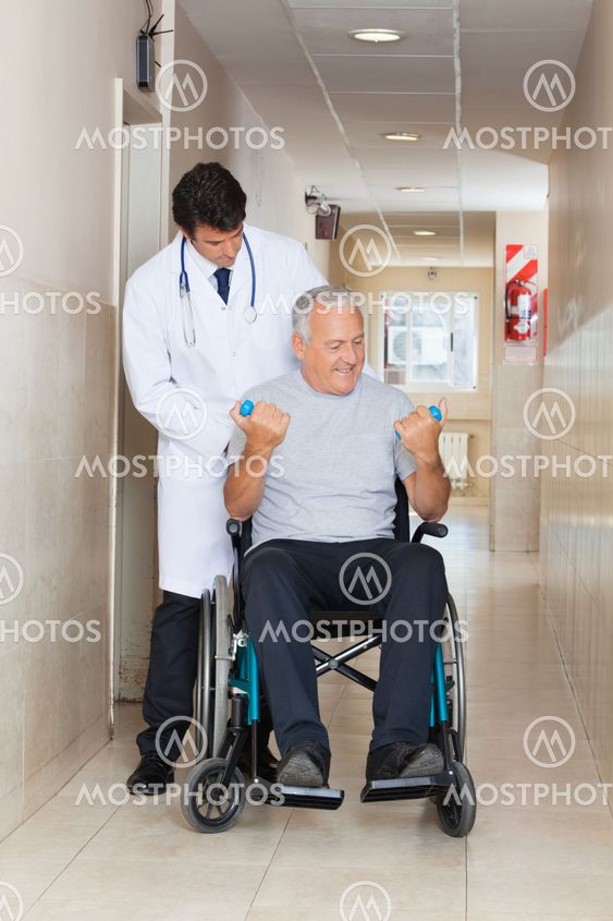 Doctor Giving Muscle Training To The Senior Man