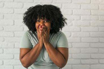 African American woman expressing pure joy with an...