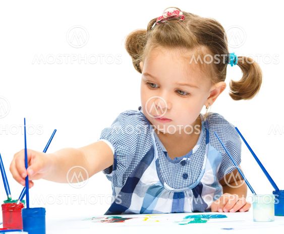 Little girl is painting with gouache