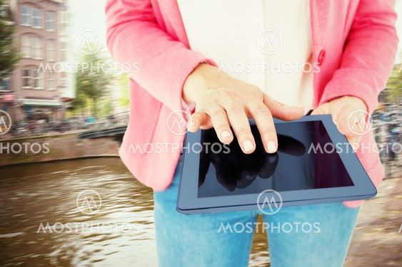 Composite image of elegant brunette using tablet