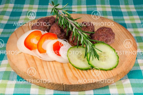 Cevapcici on a wooden dish