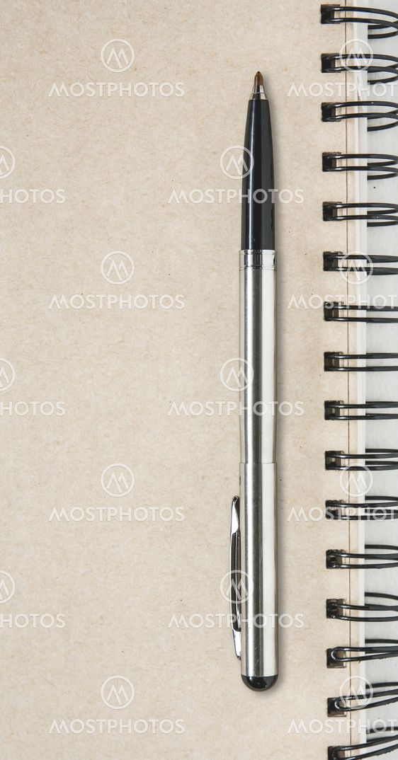 A pen on a spiral notebook