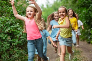 Kids, children running on green meadow, forest....