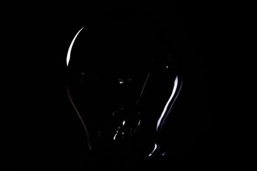 Close-up of electrical bulb on black background