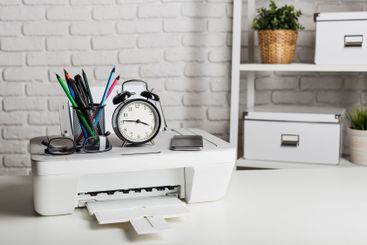 Organizing a home office workspace with a printer,...