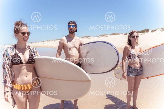 Boys and girls teen surfers with surfboards