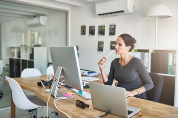Business, pregnant woman and thinking by computer in...