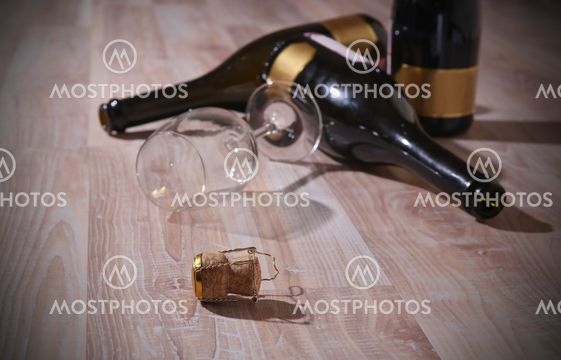bottles with wine and empty wine glass