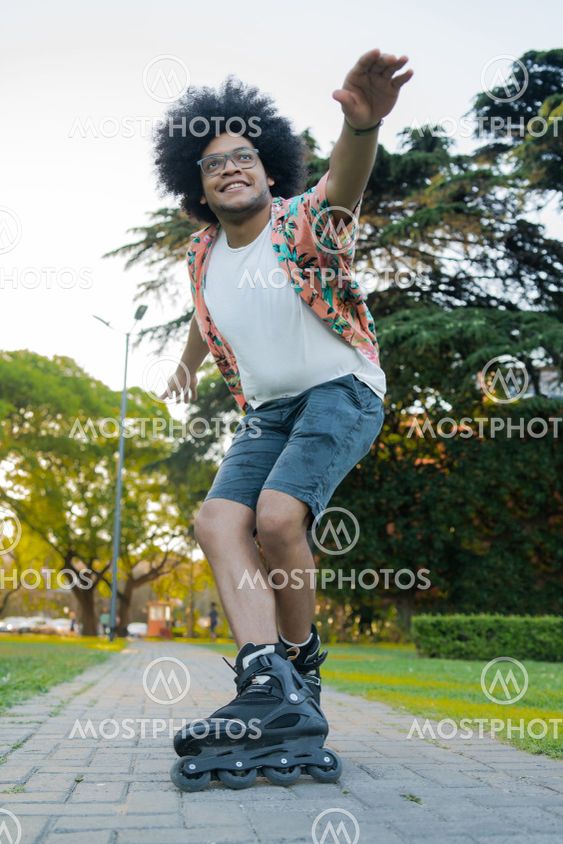 Latin man rollerskating outdoors.