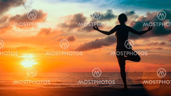 Surreal yoga silhouette of woman on the Sea beach.