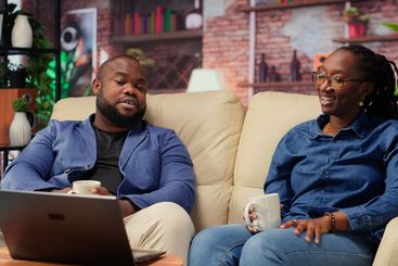 Young couple enjoys a quiet evening at home with warm...