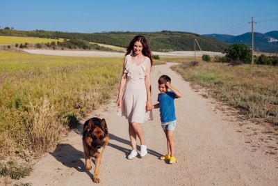 mom with baby and dog walking in nature travel walk...