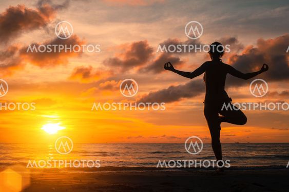 Yoga practicing at sunset, serenity and meditation.