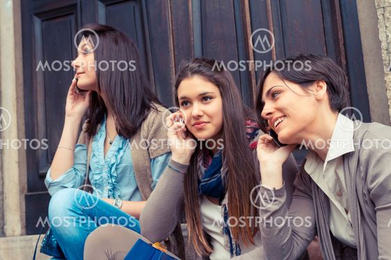 Group of Women Talking on Mobile Phone