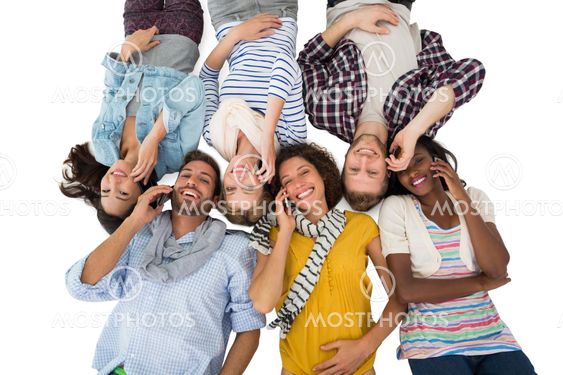 Happy group of friends lying on the floor on their phones