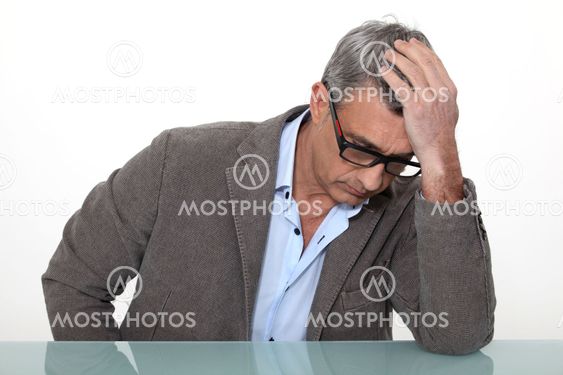 Desperate man sitting at a desk