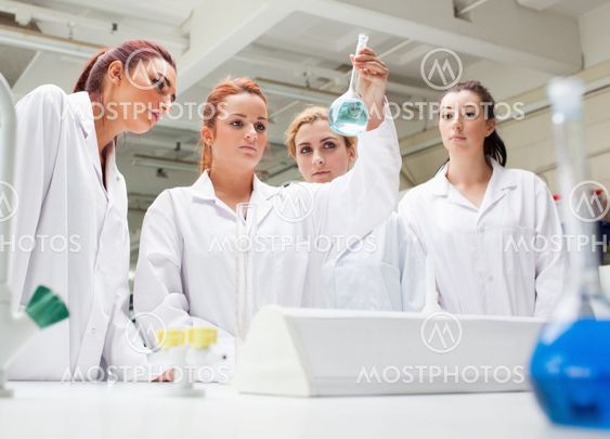 Chemistry students looking at a liquid