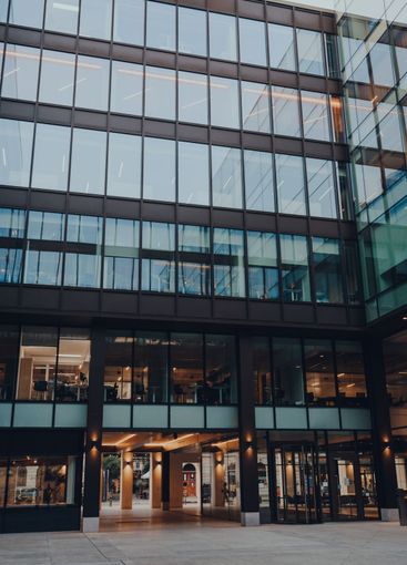 Exterior of a modern glass office building in the City...