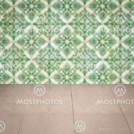 Wood table top and blur vintage ceramic tile pattern wall