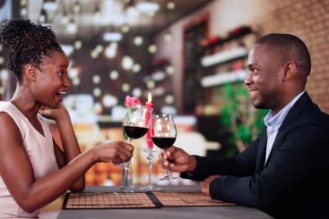Portrait Of Romantic Couple Toasting Red Wine