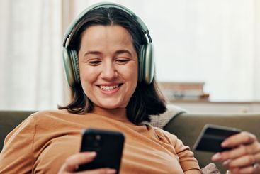 Smile, woman and phone with credit card at house of...