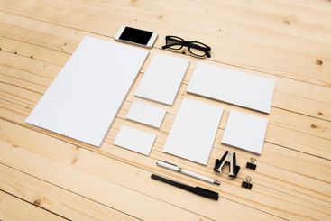 Workspace arrangement with blank stationery, smartphone,...