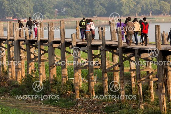 People crossing wooden bridge in Burma