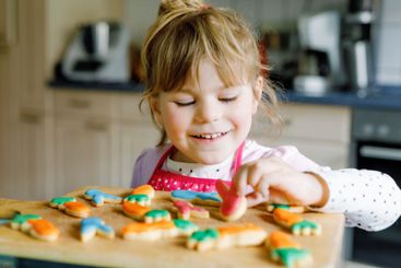 Cute little toddler girl and fresh baked homemade Easter...