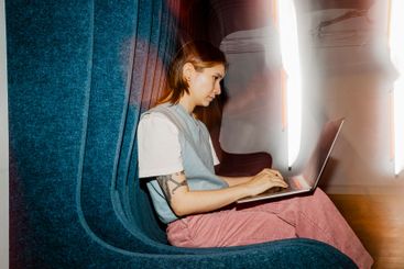 Female entrepreneur using laptop while sitting on seat