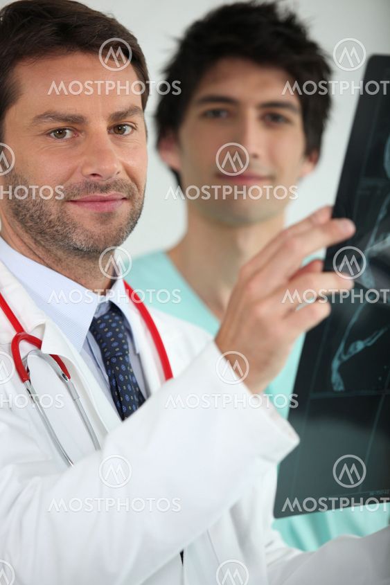 Two medics examining an X ray