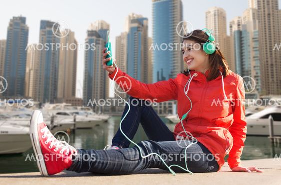happy young woman with smartphone and headphones