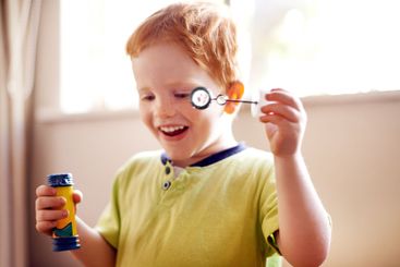 House, blowing bubbles and boy with fun, excited and...