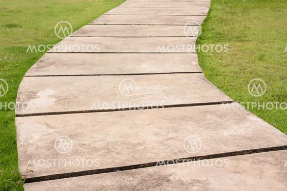 Curved path and green grass background