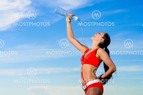 sport girl in red uniform with a bottle of water
