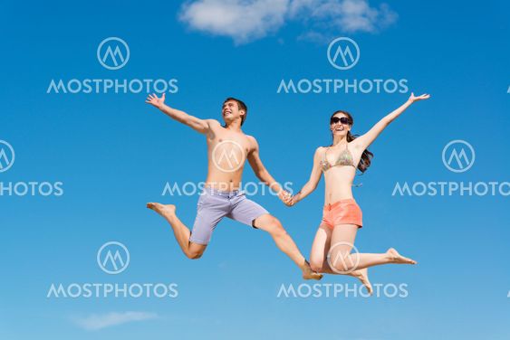 couple jumping together