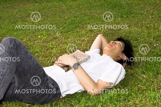 asia man relax on the grass