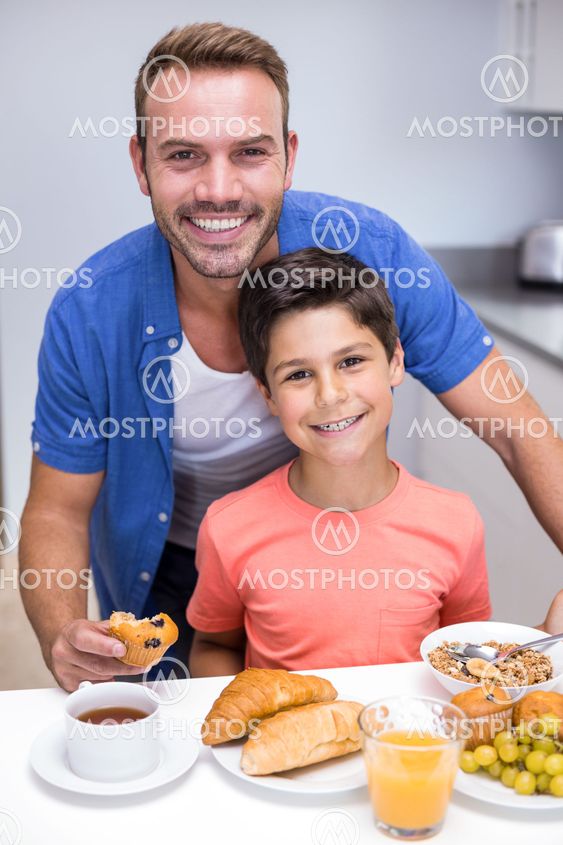 Father and son having breakfast
