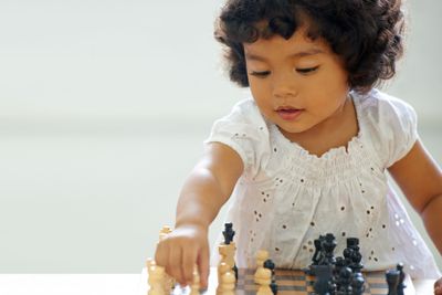 Girl, child and chess play for learning growth,...