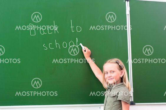 Schoolgirl writing on a blackboard