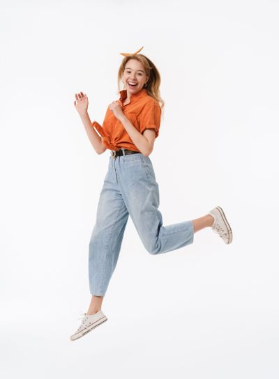 Full length portrait of pretty young woman wearing...