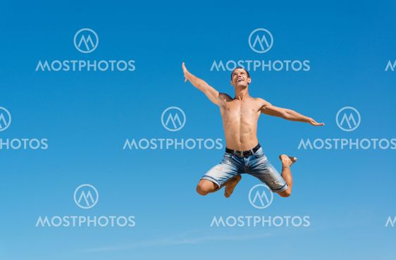 man jumping on the blue sky background