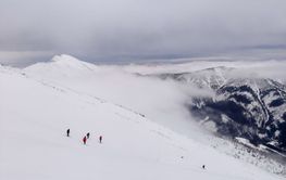 people skier and snowboarders in front of steep slop free...