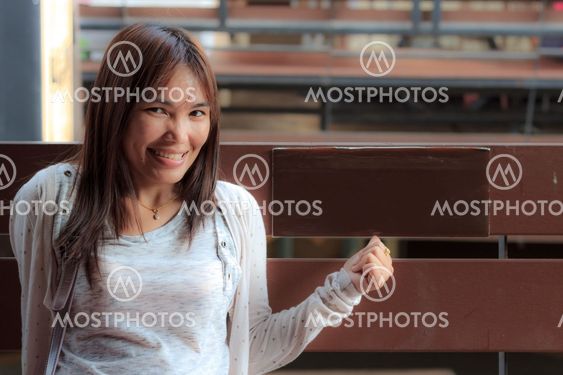 Smile asian woman sit on chair.