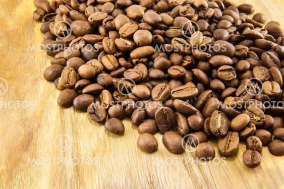 Coffee beans on vintage wooden board