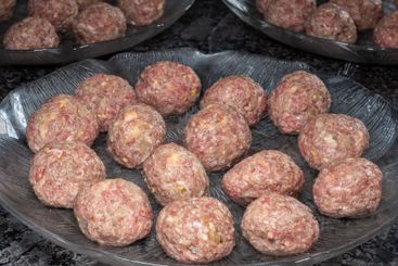 Traditional Swedish meatballs uncooked prepared on glass...