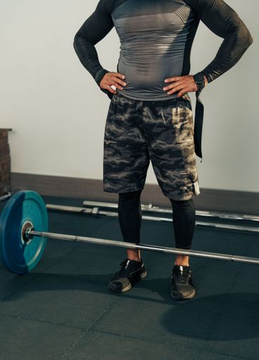 Fitness enthusiast preparing for weightlifting in a gym...
