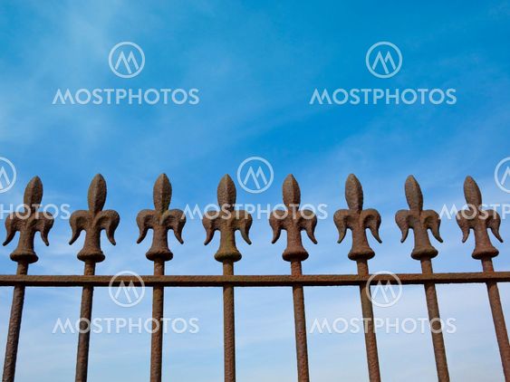rusty fleur de lys railings