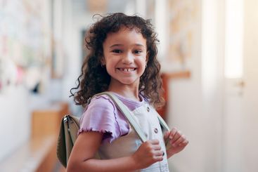 Happy, backpack and portrait of child in school for...