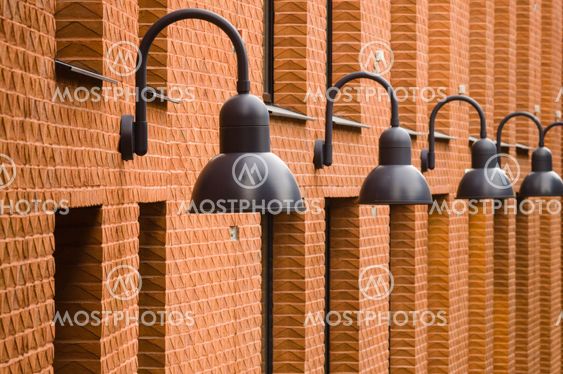 Modern brick wall with black lamps